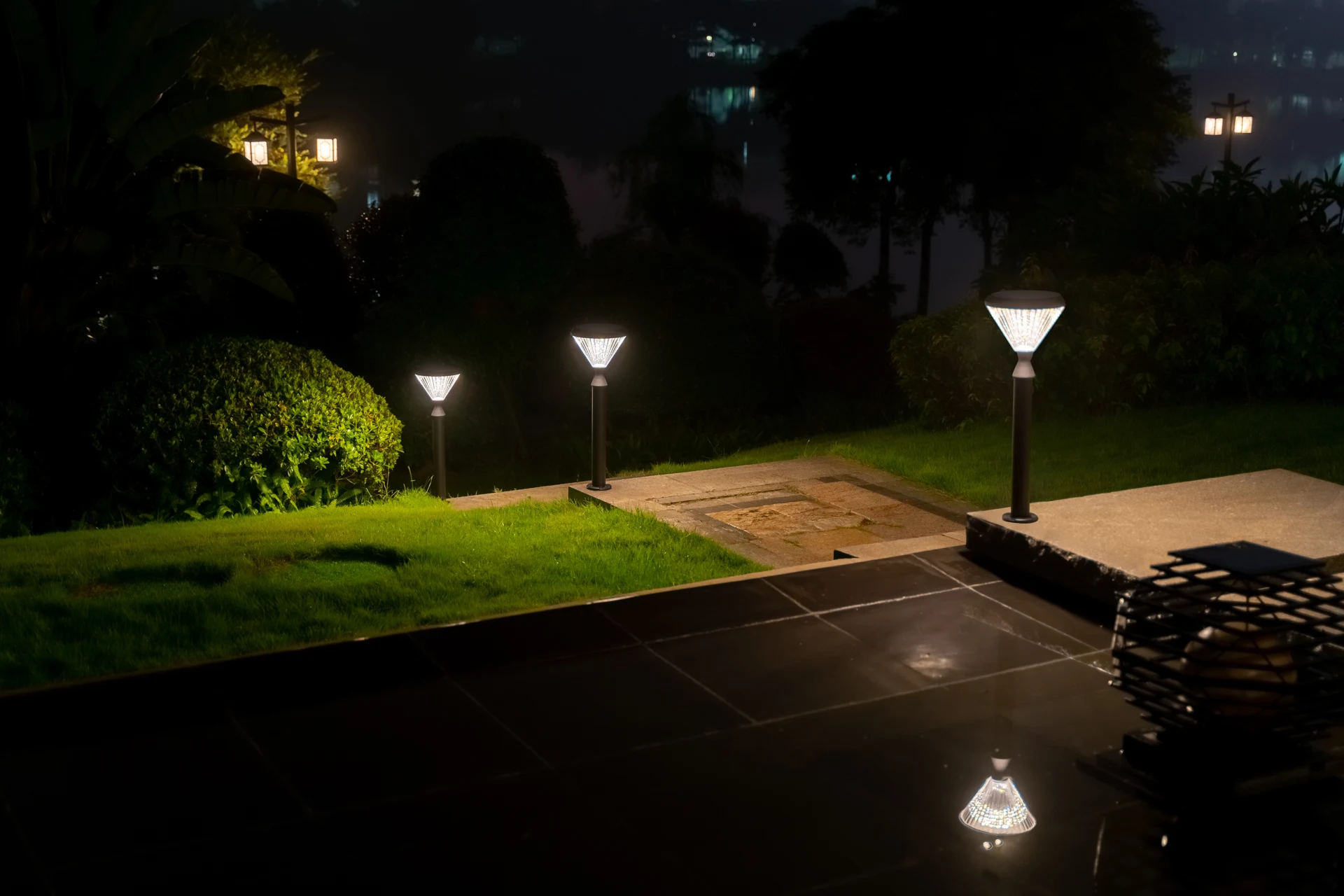 Multiple heights of SGL-4505 solar bollards lining hillside garden slope