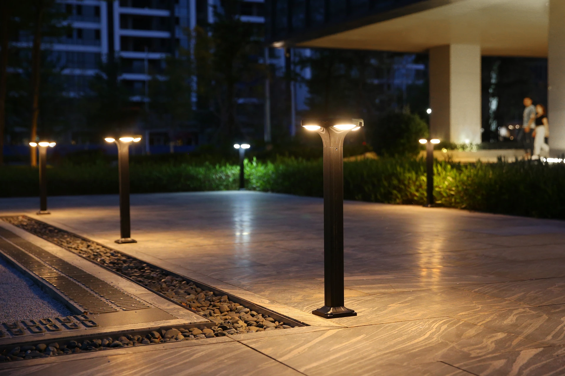 SLL-2804 clover solar bollard beside reflecting courtyard pool