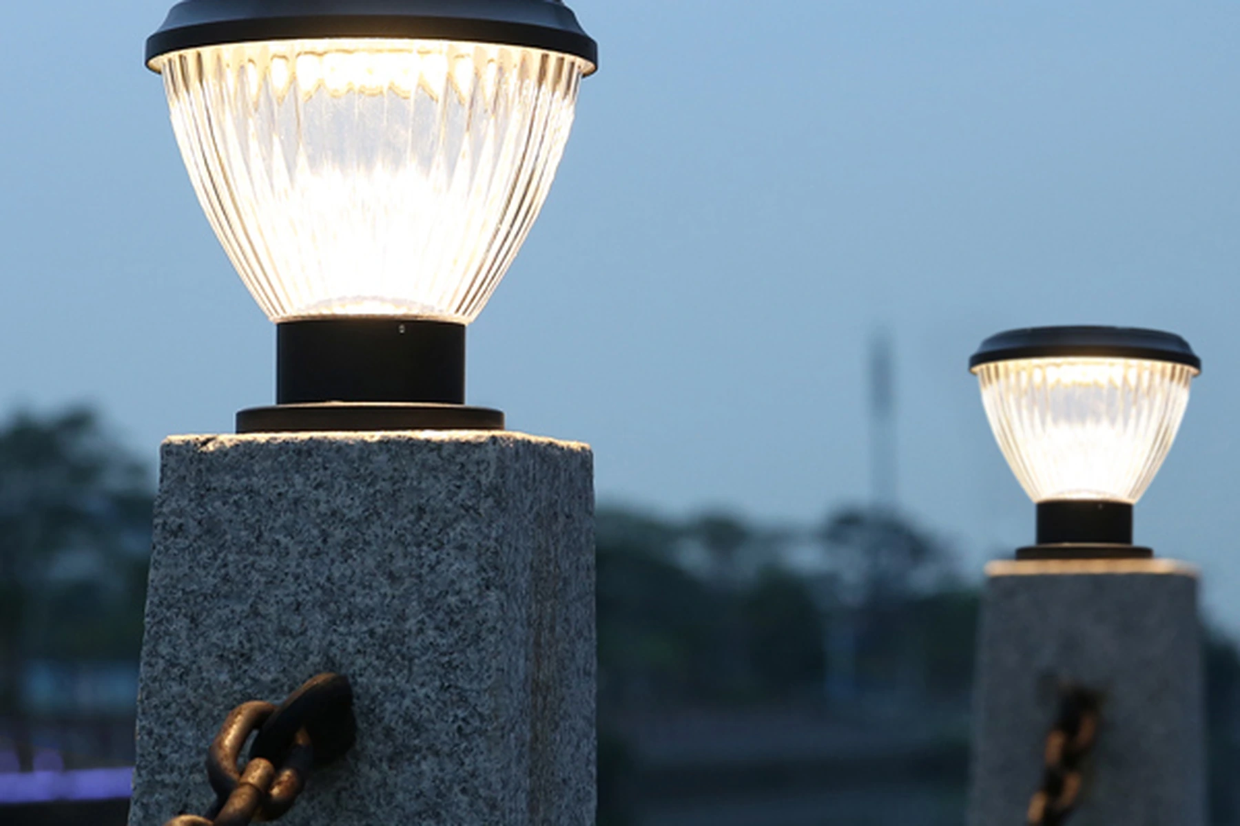 SPL-4104 solar pillar lights mounted on foreground granite column with chain fence