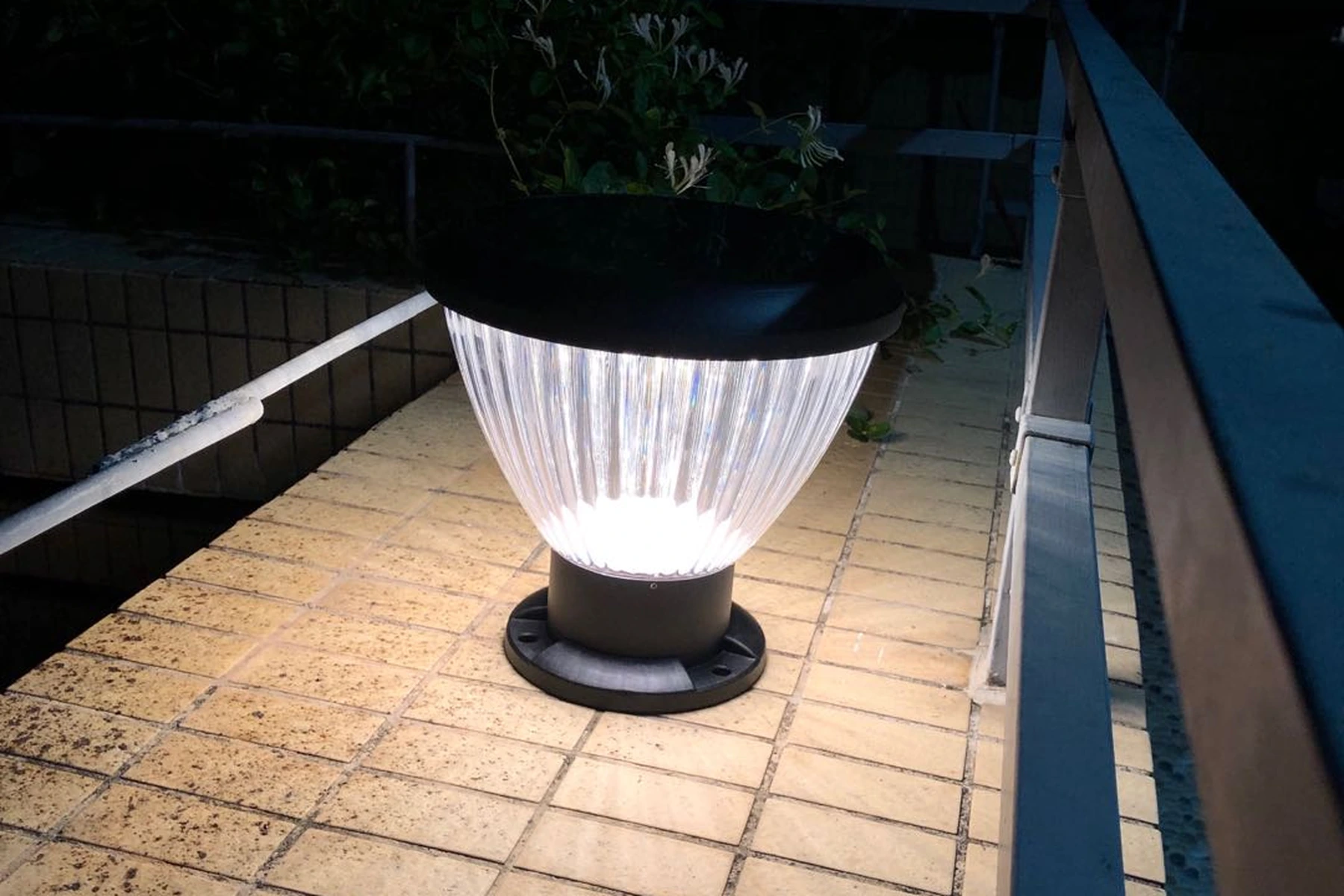 SPL-4104 pumpkin pillar light mounted atop masonry boundary gate column