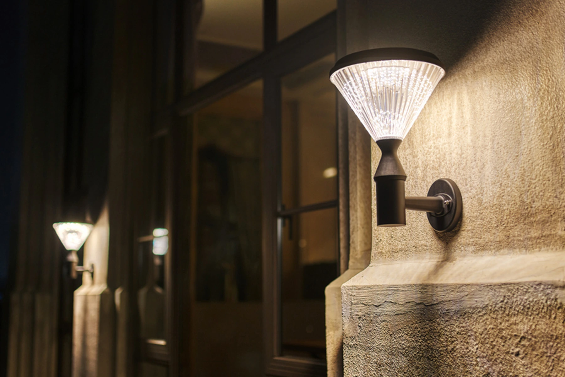 SWL-4005 diamond solar wall sconces installed on architectural villa stucco and glass facade