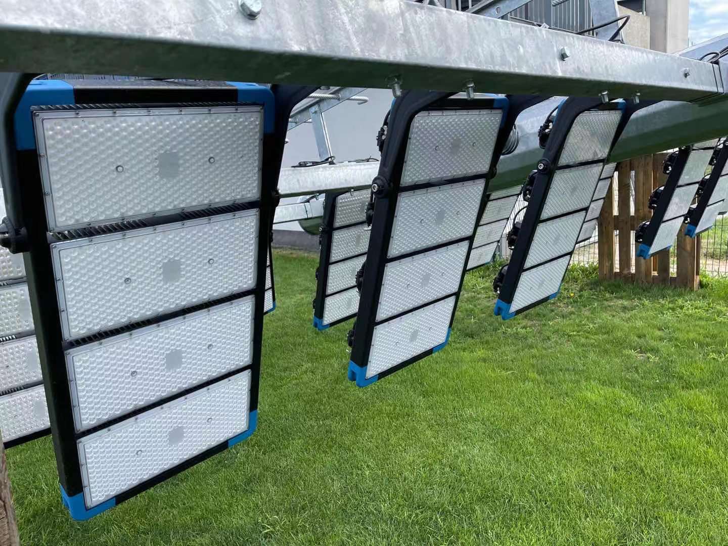 Multi-tier mast — TPK floodlights aimed and bracketed per tier