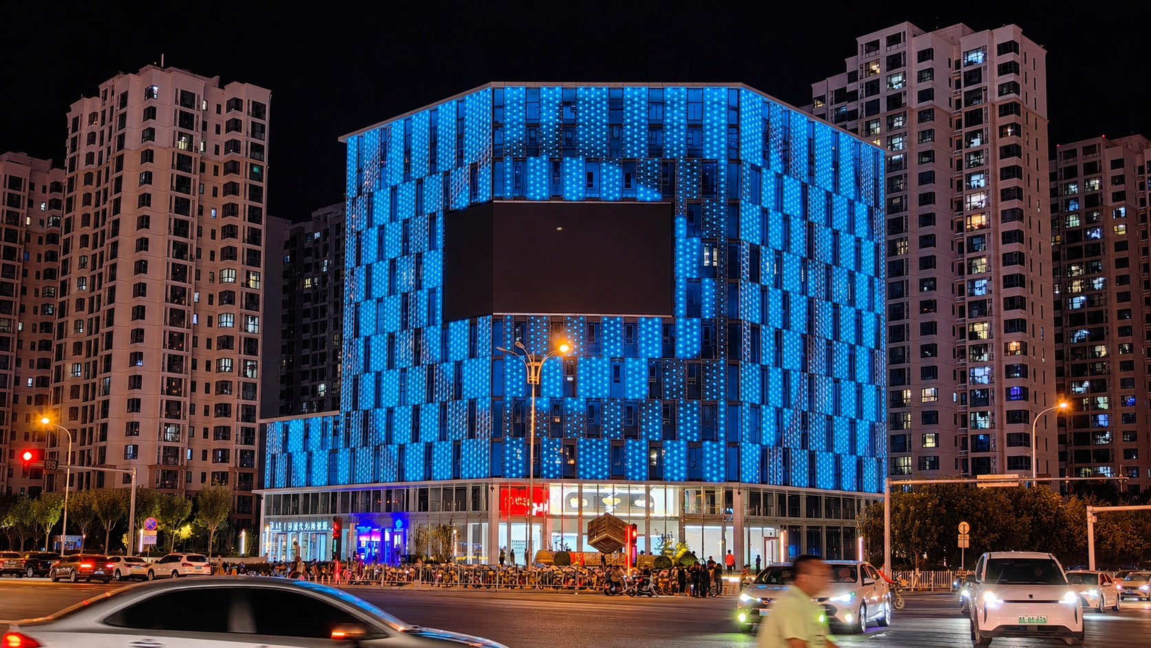 Tianjin Haitang Building facade pixel lighting at night — 4,495 custom six-pointed star DMX512 RGBW fixtures across 8,000 m² parametric curtain wall by TPK Lighting