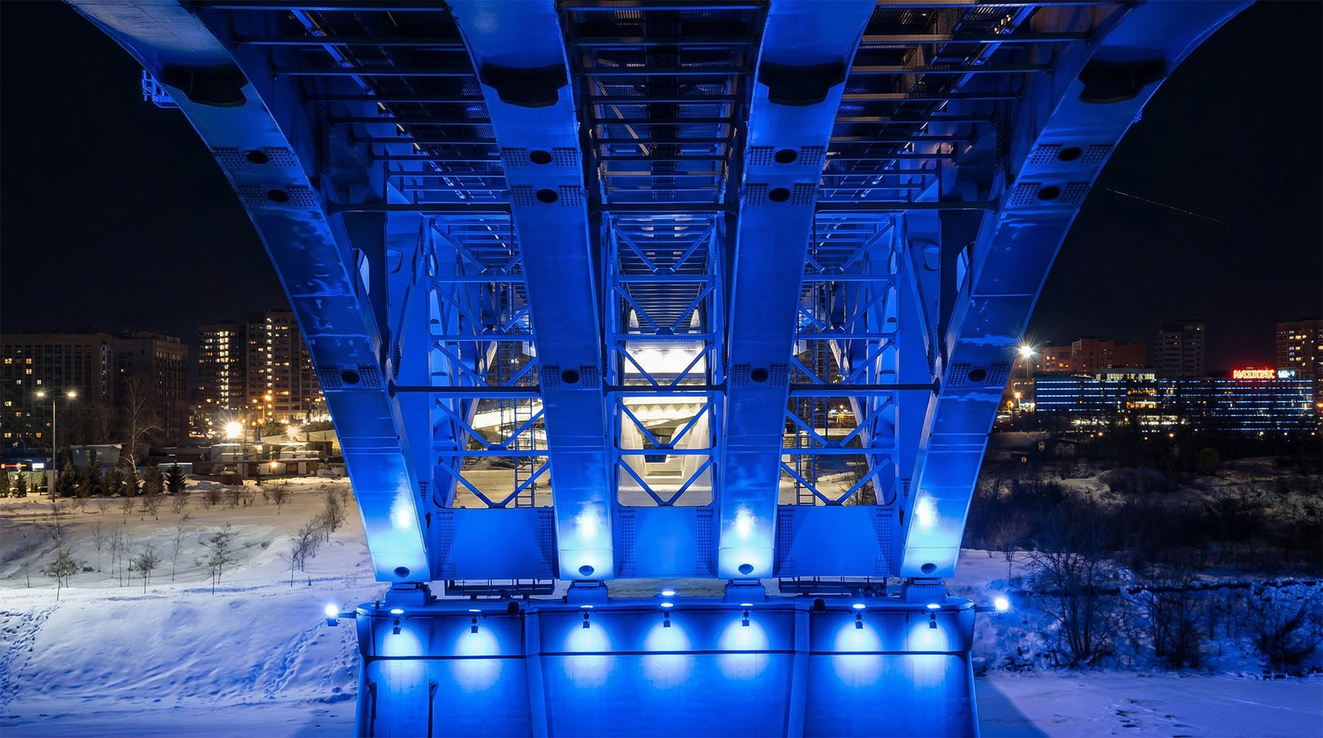 Dynamic DMX512 controlled bridge night lighting reflecting on the frozen river