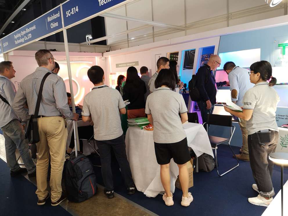 Visitors reviewing architectural lighting products at the TPK booth.